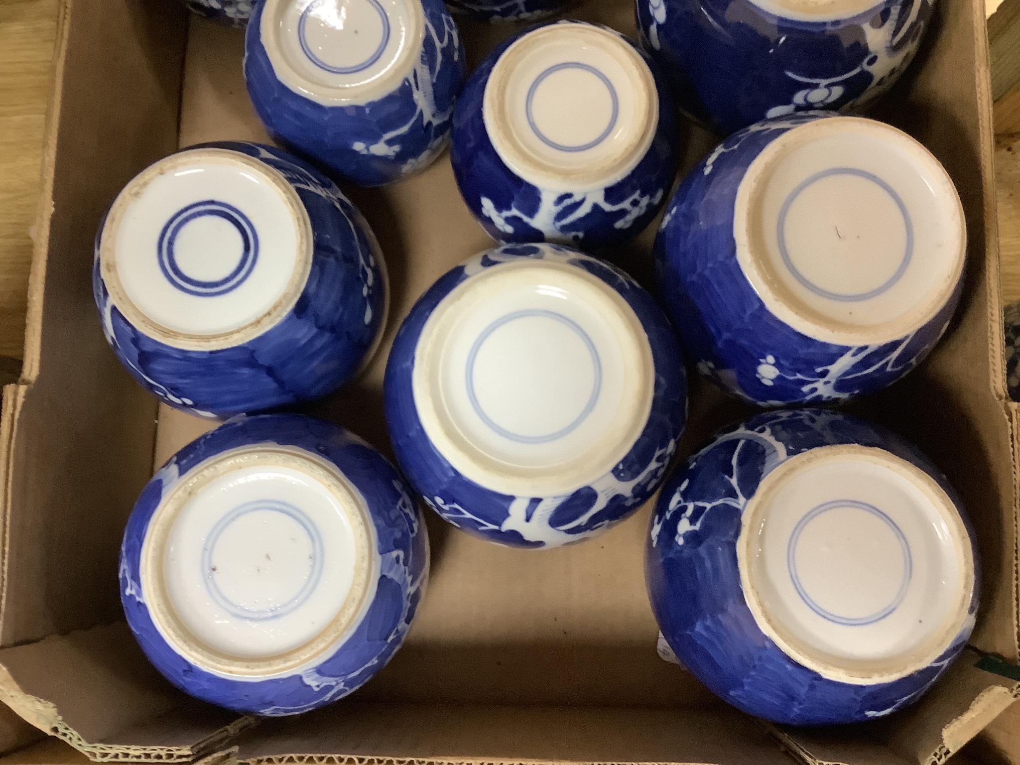 Fourteen Chinese blue and white 'prunus' jars, some with covers